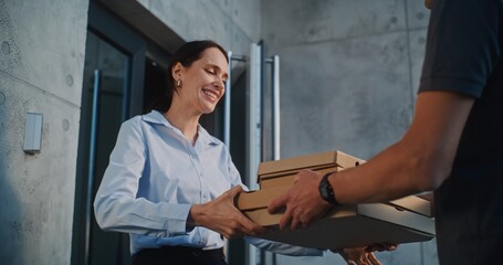 Man Working in Pizza Delivery Service, Brining Restaurant Food for Client Working in Modern Office Building. Beautiful Businesswoman Taking Pizza in Cardboard Boxes from Delivery Man. Slow Motion.