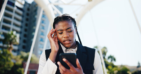 Frustrated, black woman and headache with phone in city for bad news, burnout or mistake. Female...