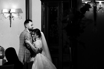 Romantic wedding couple embrace, a tender moment captured in black and white.
