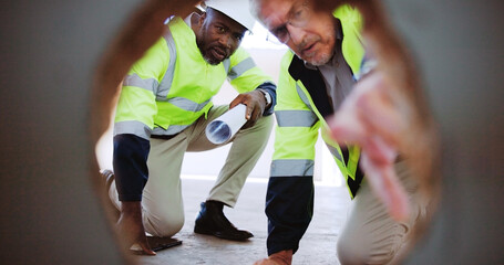 Architecture, collaboration and pointing with construction worker people on building site together. Development, engineering and infrastructure with industrial team from hole POV for inspection