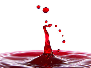 Captivating close-up of a red liquid drop splash against a pristine white background, showcasing dynamic movement and fluid tension with a few perfectly formed droplets hovering mid-air.
