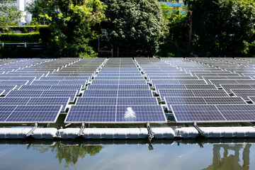 Selective focus to solar power station. Solar photovoltaic power station on water. Solar panels or solar cells on buoy floating in lake.  Power plant with water.