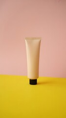 Pink and Yellow Pastel Moisturizer Tube on Colorful Background