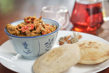 Beef curry served with homemade sourdough pita breads on table. Healthy, diet eating food. Low calories bread.