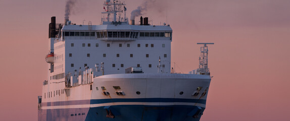 MARITIME TRANSPORT - Passenger/Ro-Ro Cargo Ship sails on the sea at sunset
