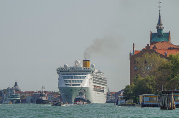 Italian luxury cruise ship Victoria cruising the Giudecca Canal with tug boats towards the cruise...