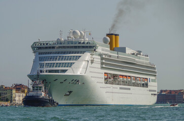 Italian luxury cruise ship Victoria cruising the Giudecca Canal with tug boats towards the cruise...
