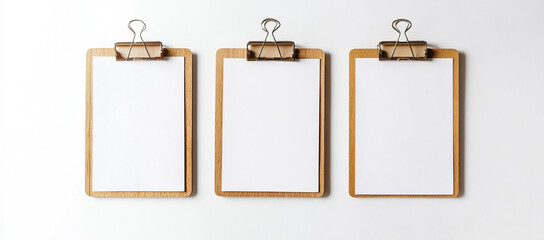 Three wooden clipboards with blank white paper