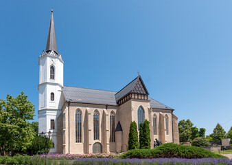 St. Elizabeth Basilica in Sárospatak, Hungary. A Gothic Catholic basilica with a tall white spire, large windows, and castle walls. Historic landmark under the Archdiocese of Eger.