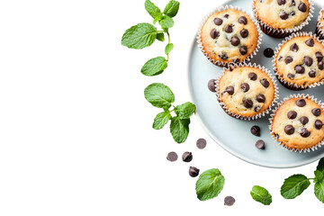 Delicious chocolate chip muffins with fresh mint leaves on a black background