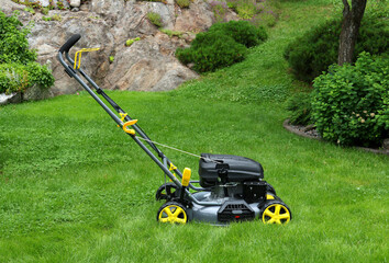 Brand new lawnmower in long grass, ready for work
