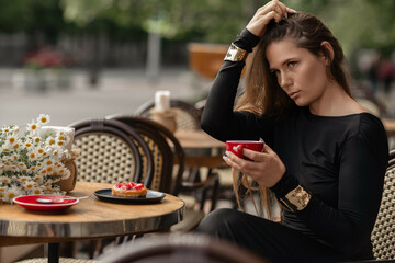Cafe Woman Coffee Donut: Brunette sips coffee with donut at outdoor cafe, day, relaxing.