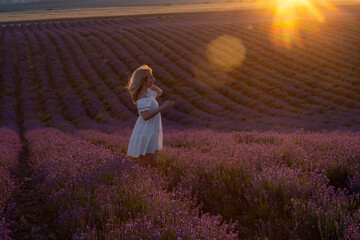 Lavender Woman Sunset: Tourist walks in field at sunset for photos on vacation in Provence.