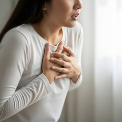 Woman Holding Chest in Pain &ndash; Possible Heart Attack or Anxiety Symptoms