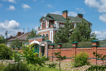 Modern city mansion with garden behind a gated wall in the old town.