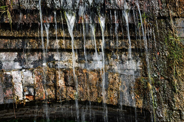 Waterfall in the old castle, close-up. 