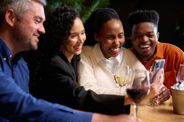 Black and Caucasian friends on a video call together