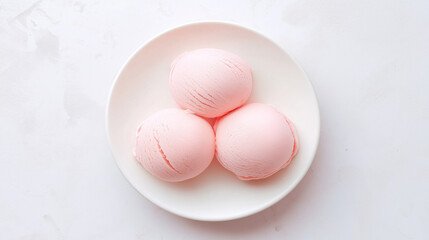 Three pink ice cream scoops on a white plate, a delicate and dreamy dessert moment