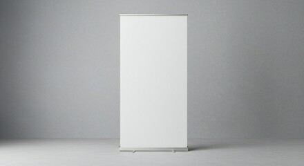 Minimalist composition featuring a white banner stand on a smooth gray surface, softly lit for an understated professional ambiance.