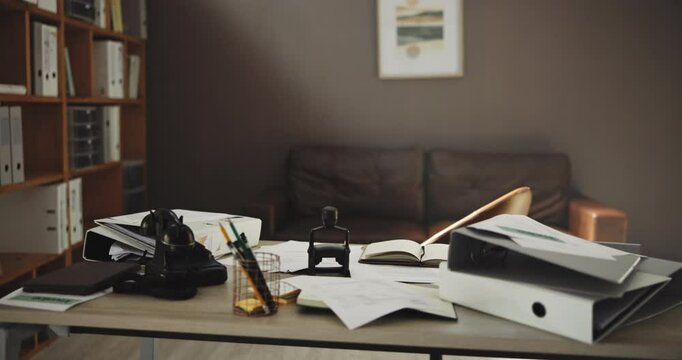Business, table and setup with documents in office for bookkeeping, folder and disorganized. Paperwork, equipment for company information, finance management and audit portfolio in empty workspace