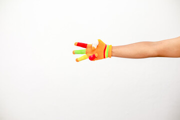 Arm wearing colorful novelty finger puppets on white background for kid concepts