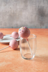 A view of a cake pop in a small glass.