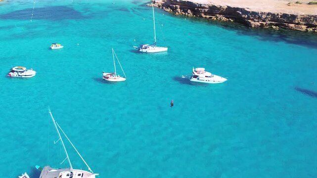 Aerial Drone View of group of Yachts or Flotilla in Formentera's Crystal Clear Cove