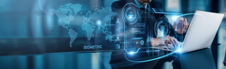 A businessman uses his laptop to analyze Biometric data, observing fingerprint and facial...