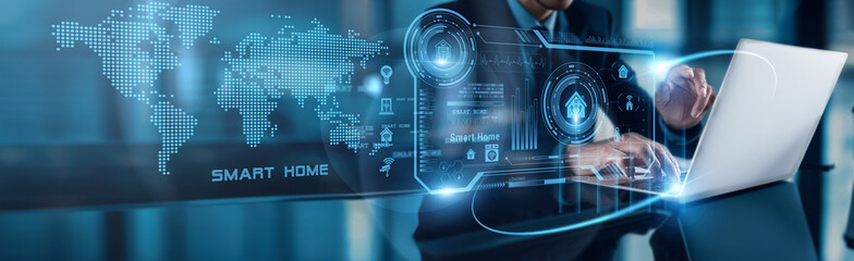A businessman uses his laptop to analyze smart home data, observing market adoption growth on the...