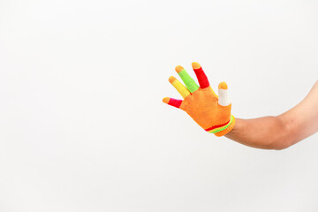 Colorful glove on hand symbolizing diversity and inclusion with a bright background ready for...