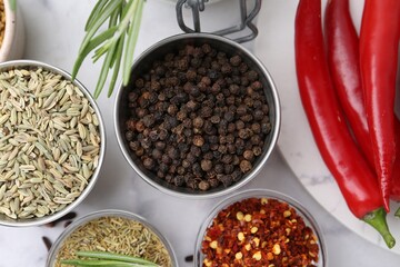 Different aromatic spices on white table, flat lay