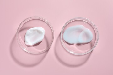 Different cosmetic products in Petri dishes on pink background, flat lay