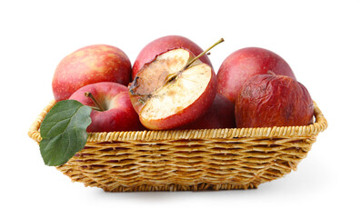 Spoiled apple and good ones in basket isolated on white