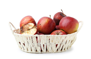 Spoiled apple and good ones in basket isolated on white