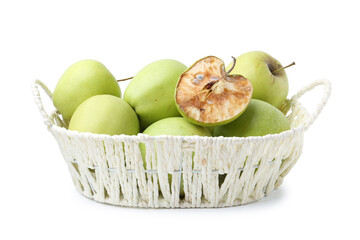 Spoiled apple and good ones in basket isolated on white