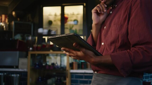 A African manager buying stock on the tablet for the business