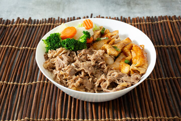A view of a bowl of beef gyudon and chicken teriyaki.