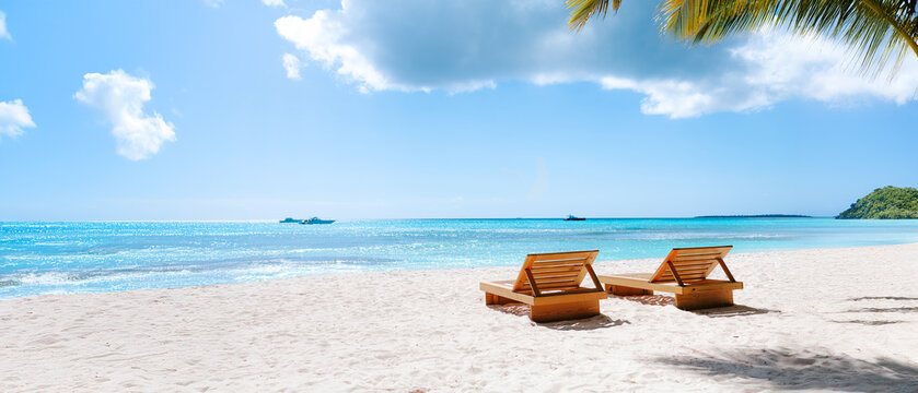 Vacation summer holidays background wallpaper - sunny tropical Caribbean paradise beach with white sand in Seychelles Praslin island Thailand style with palms