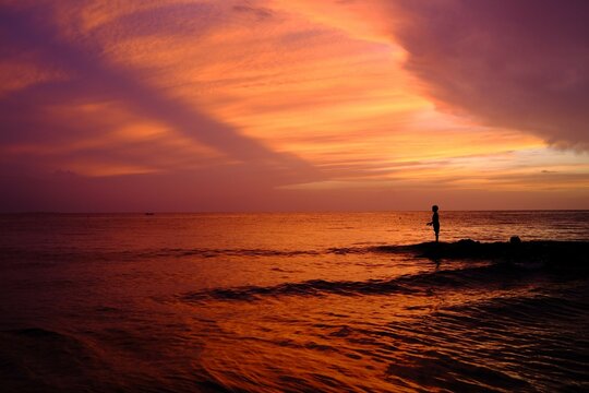 Silhouetted Figure Enjoying a Sunset