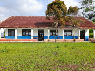 A simple school building in the village, a large green school yard with wild grass. The atmosphere...