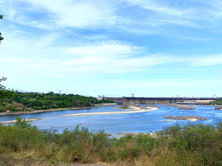 View from the thickets of Khortytsia island on the Dnieper dam under a blue spring sky shaded by a cloud cover.