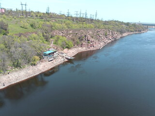 View from the Arch Bridge on the calm water surface of the Dnieper that washes the sandy shores and...