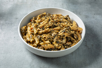 A view of a bowl of pesto chicken cauliflower pasta.