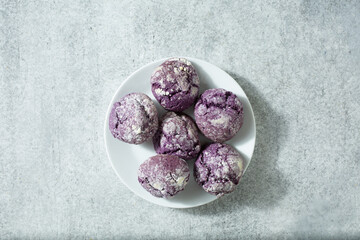 A top down view of a pile ube crinkle cookies.