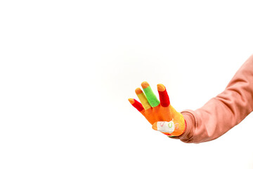 A hand wearing a colorful glove with a bandage isolated against a white background is reaching out