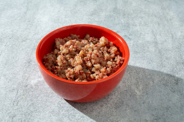 A view of a bowl of canned corned beef hash.