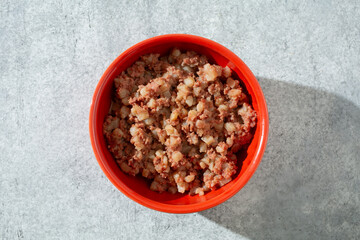 A top down view of a bowl of canned corned beef hash.