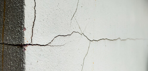 Cracked Wall Detail: A close-up reveals the intricate network of cracks across a wall, creating a...