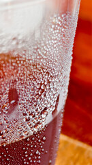 Cold Drink Condensation: Close-up captures refreshing cold drink condensation on a glass,...
