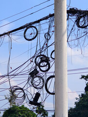 Tangled Wires: A complex network of wires, cables, and telecommunications infrastructure atop a...